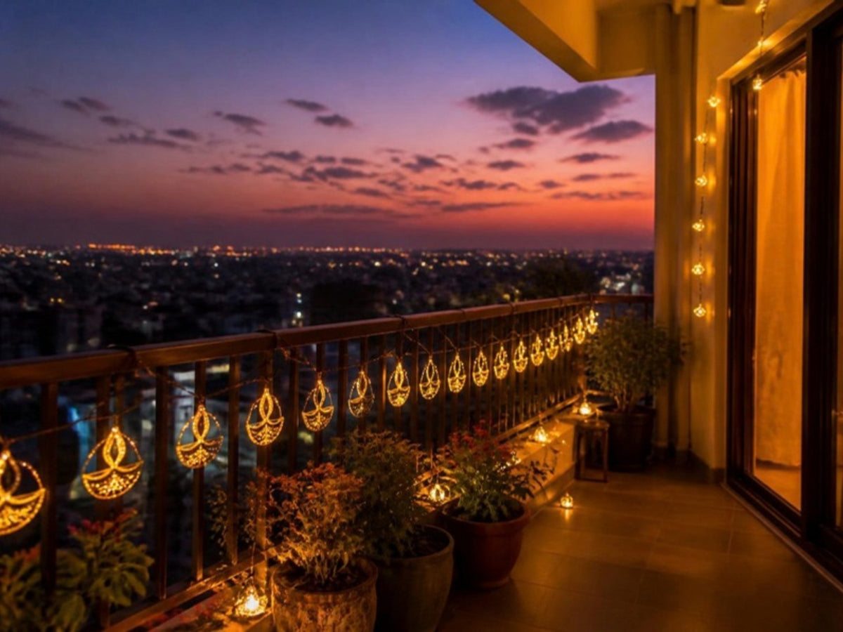 Balcony railing decorated with diya lights at dusk